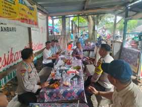 Bhabinkamtibmas Polsek Singingi Edukasi Pengunjung Pasar tentang Pilkada Damai sambil Makan Sate
